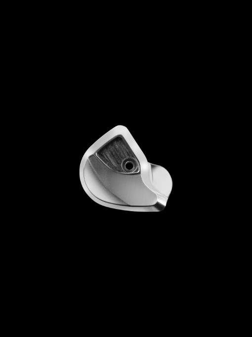 Aluminum cover on a black background showing milling marks, demonstrating the initial stages of production before reaching the final product.
