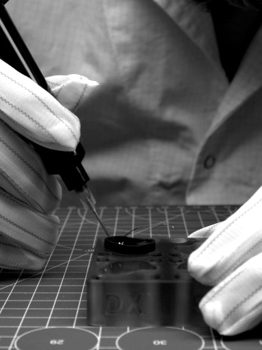 Laboratory technician during the resin insertion phase into the body of Todi in-ear monitors. Image showcasing the precision and attention to detail involved in the manufacturing process of Todi products.