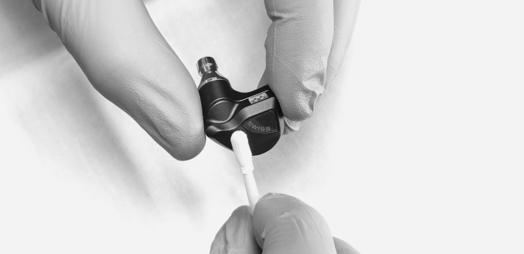 Manual cleaning of a Clariden in-ear before final packaging.