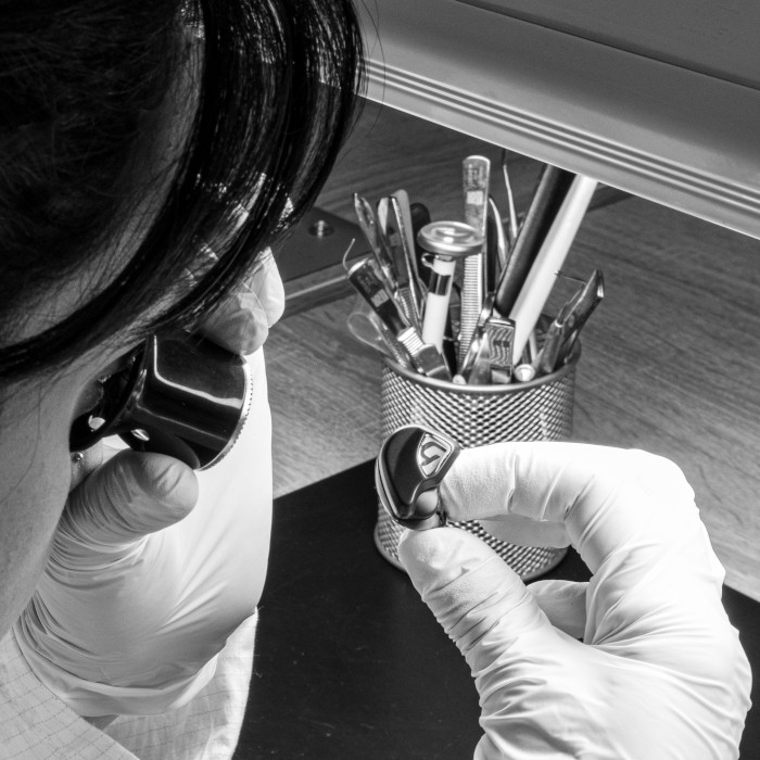Lab technician inspecting the craftsmanship of a Todi product with a monocle. Image highlighting the meticulous quality control process to ensure precision and excellence in Todi products.